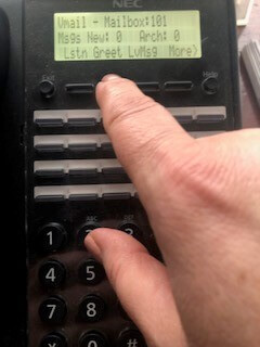 Press Greet button on NEC office phone